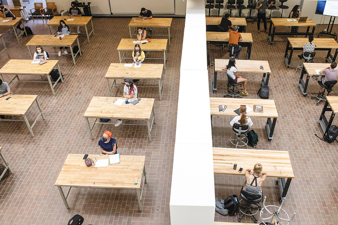 overhead view of students sitting at individual tables.