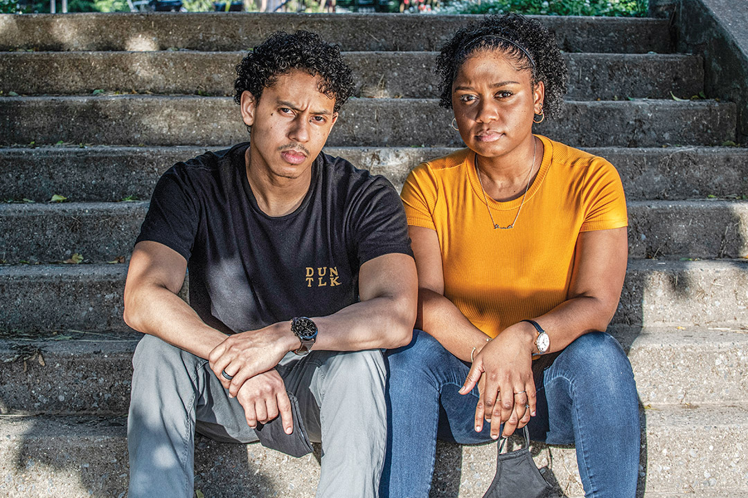 two people sitting on stone steps outdoors.