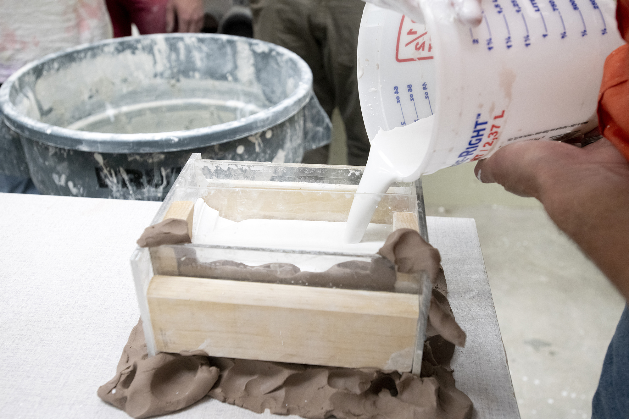 Plaster is poured into a mold system.