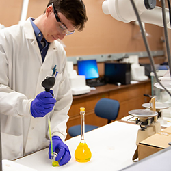 Alex Knowles working in RIT chemistry lab