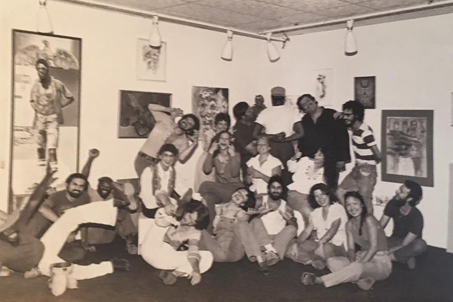 A group of people post in a photo taken in the 1970s.