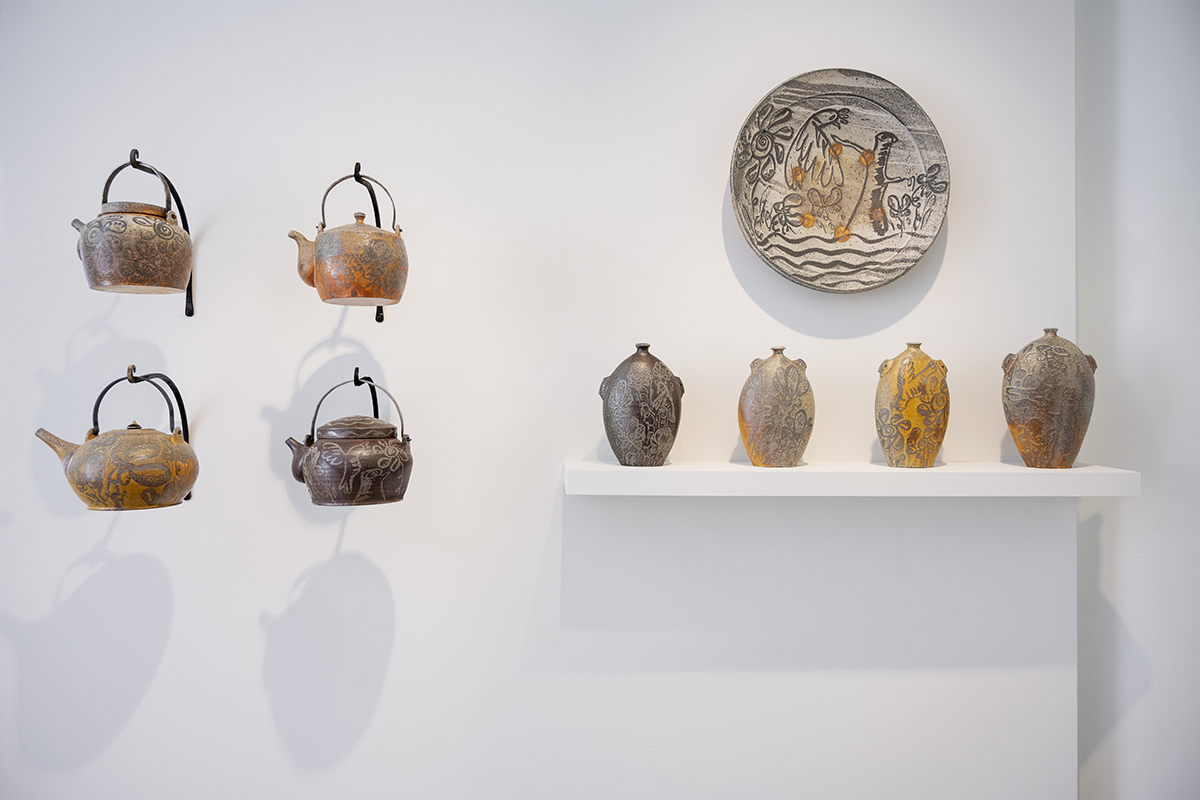 Tea pots and vessels in a gallery.