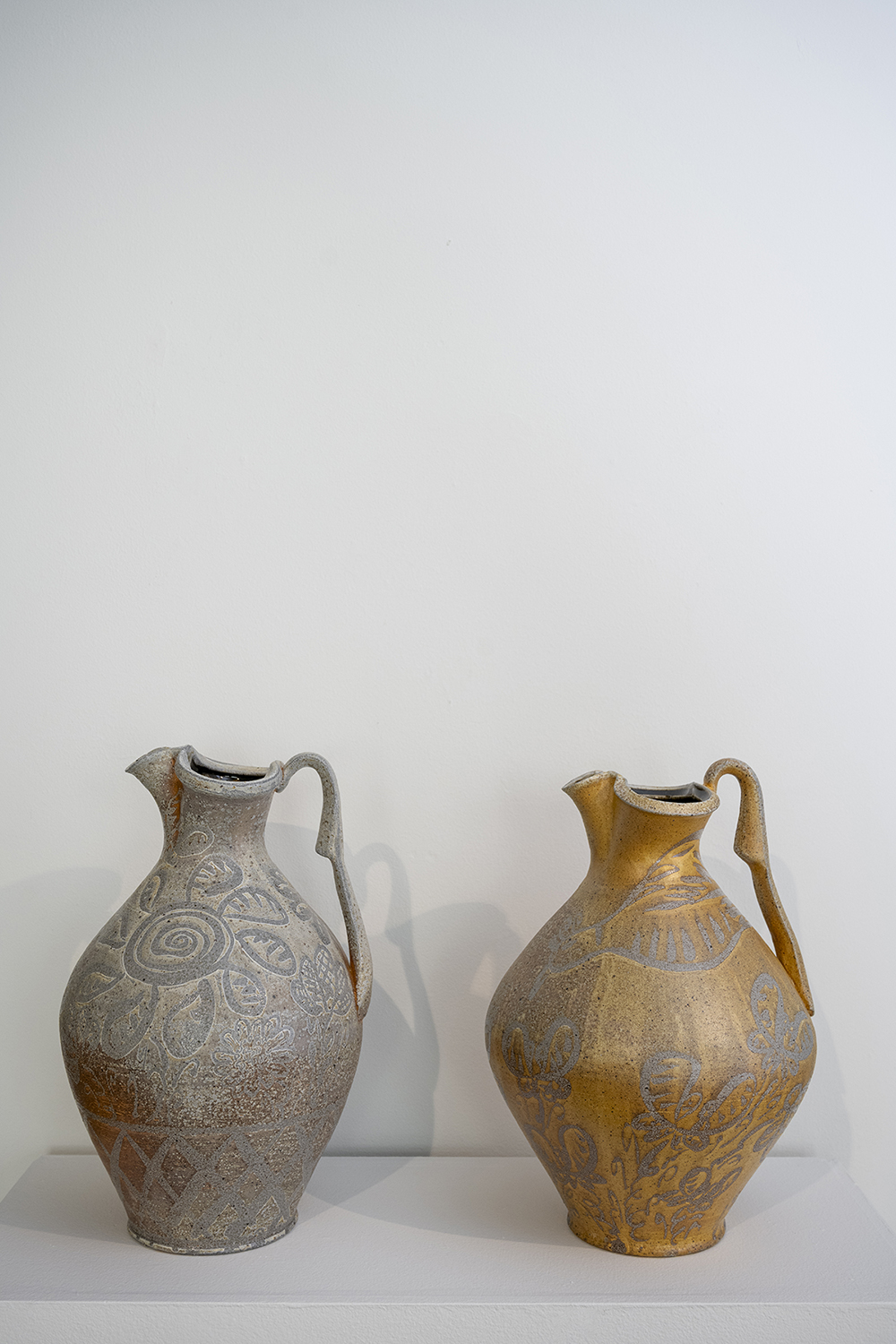 A pair of large ceramic vessels side by side.