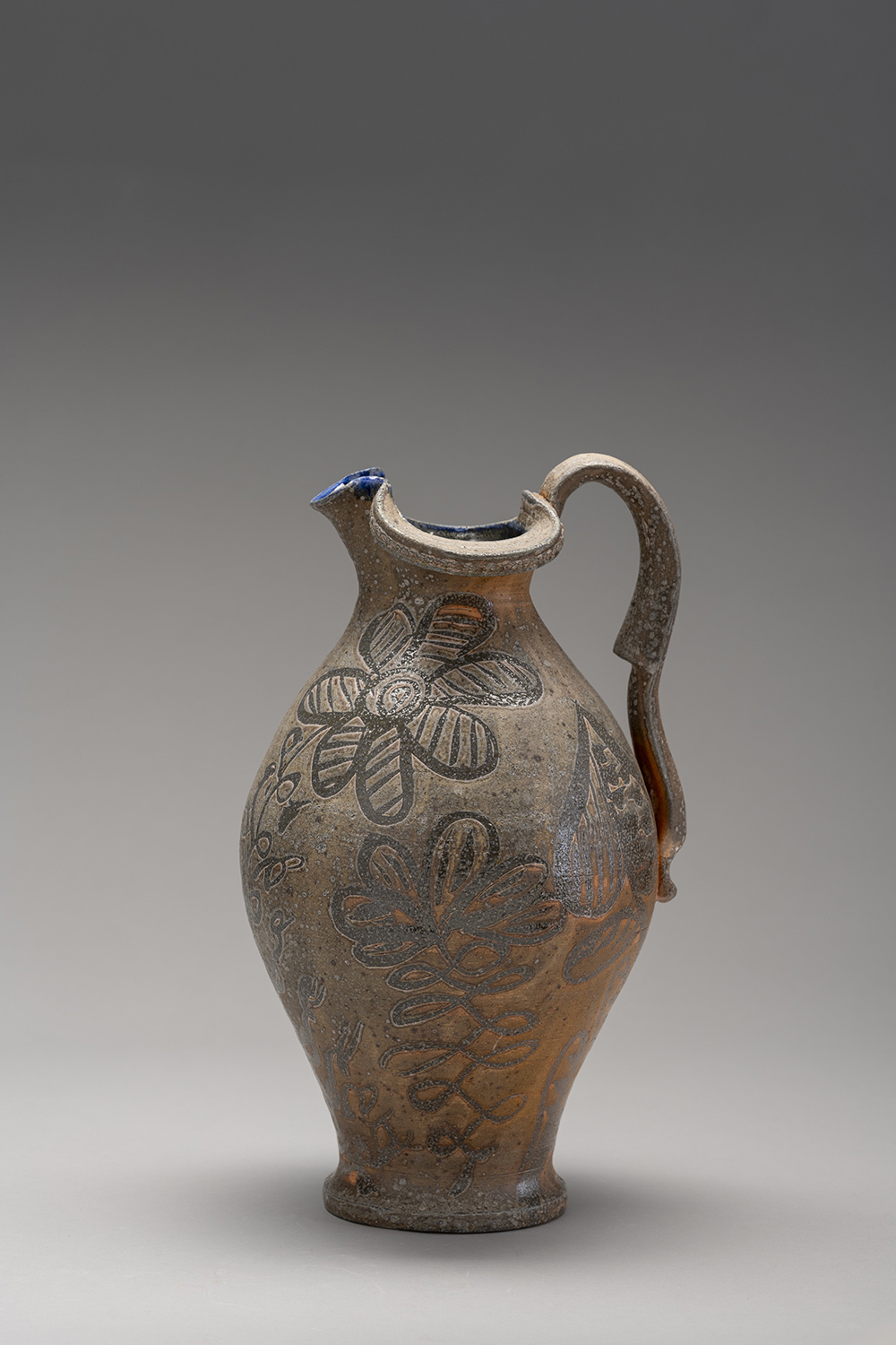 A large ceramic vessel with a handle.