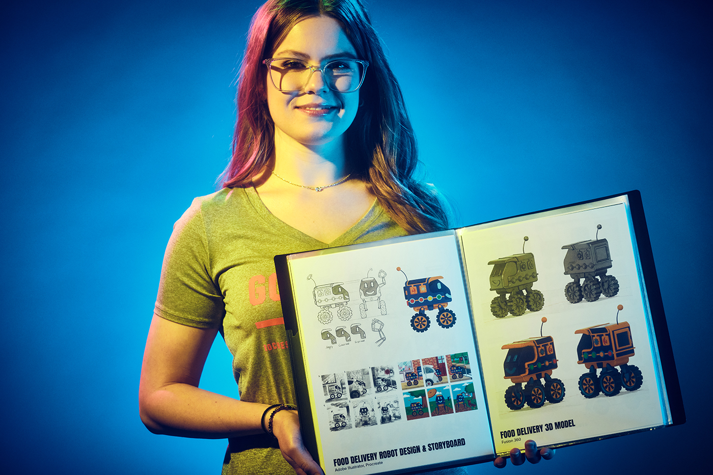Ava Guarino holds up a portfolio with her sketches and illustrations of a food delivery robot.