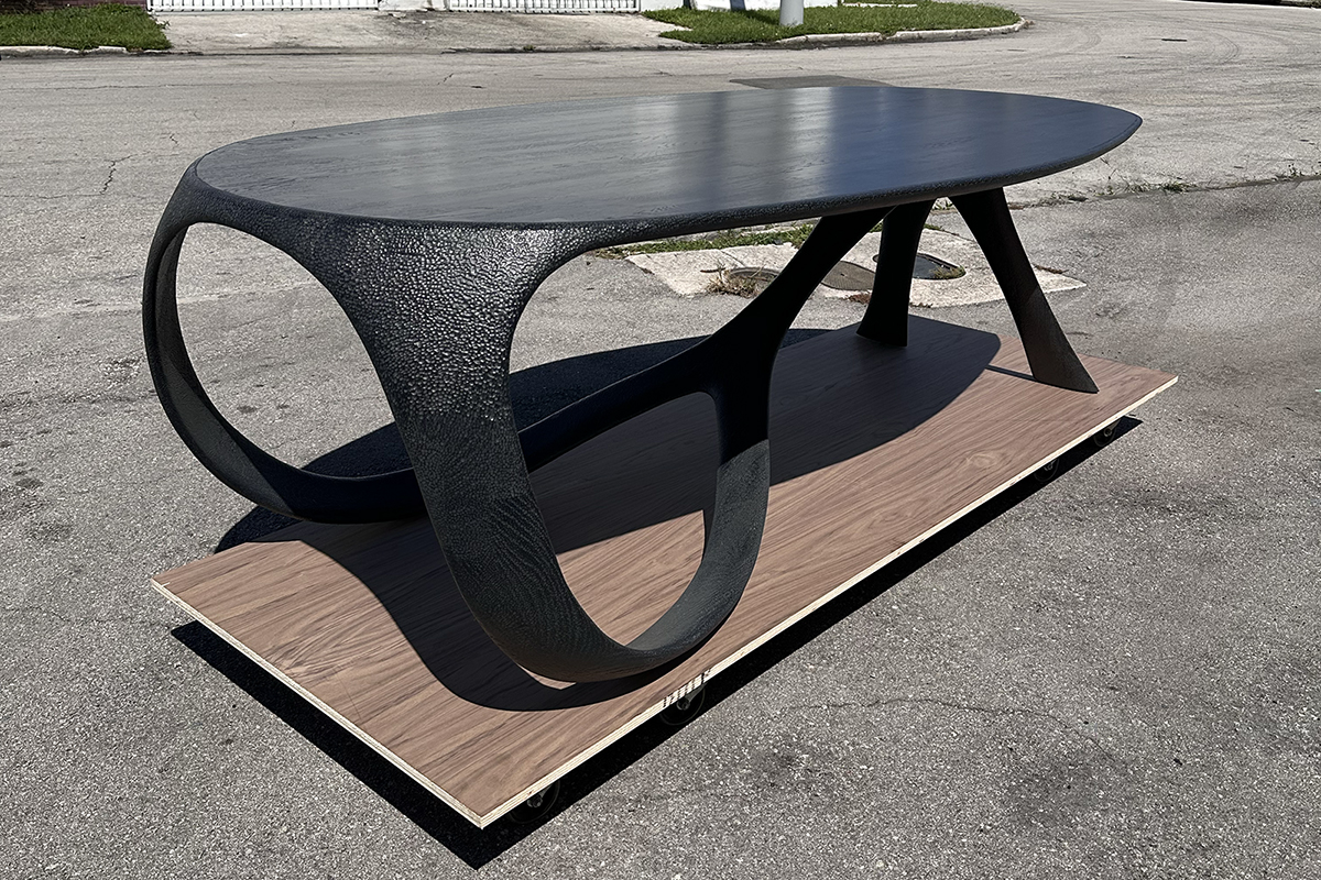 A black table on a wood platform, designed by RIT alumnus Gunther Jacobson.