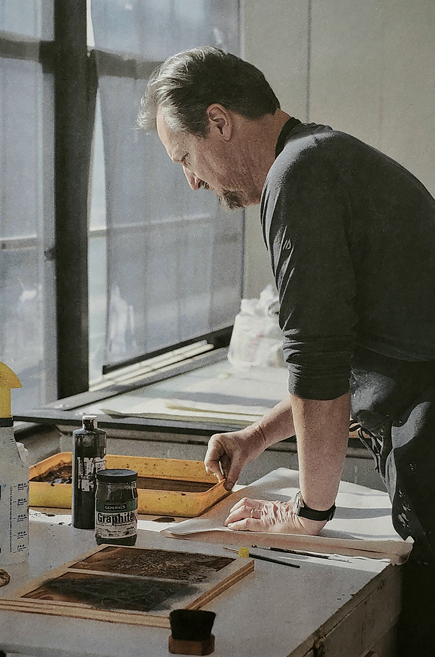 Bob Erickson working in a printmaking studio.