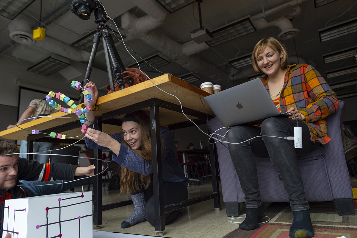 Visiting artist Kelli Anderson and a student work in tandem to create a stop-motion video.