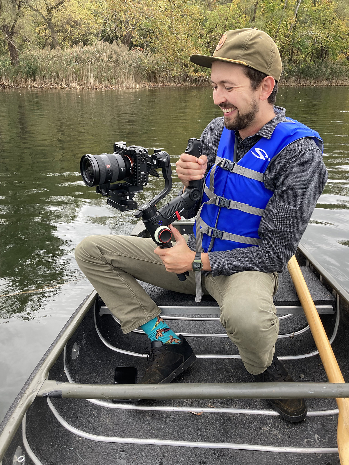 Boris Sapozhnikov sits on a canoe with a video camera. 