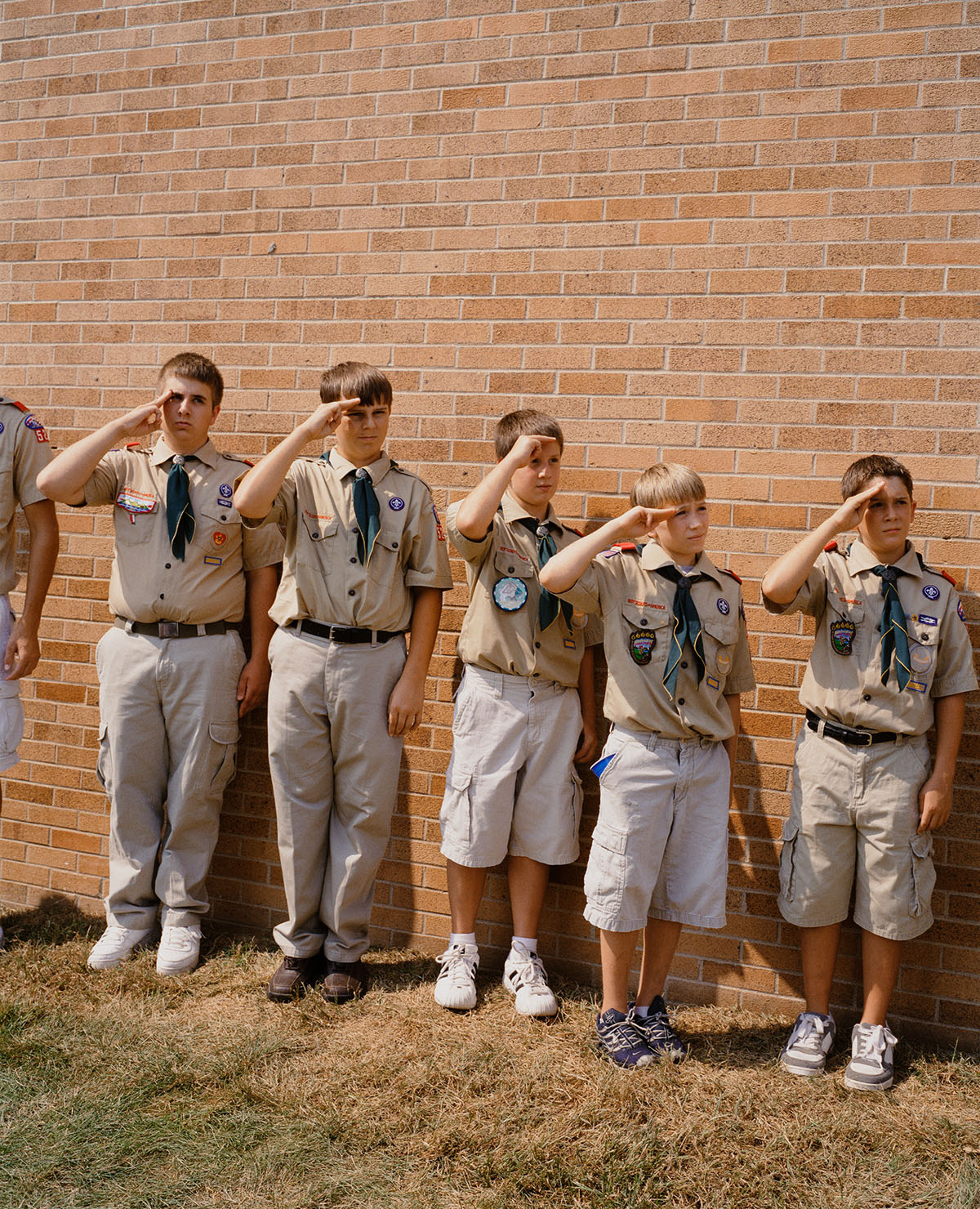 A group of boy scouts salute.