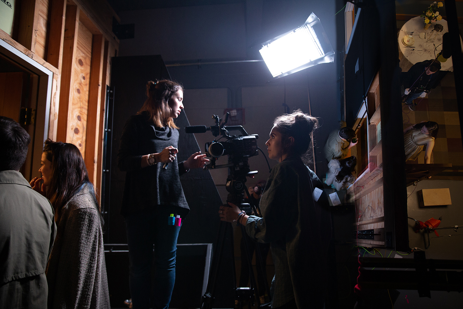 Actors offset looking towards the set with a camera pointed in the same direction they are looking