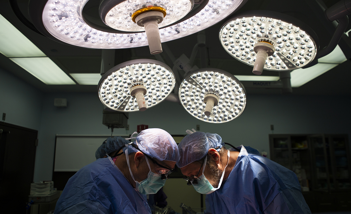 Two medical personnel in an operating room.