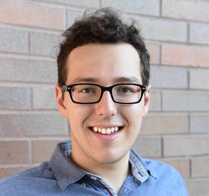 Head-and-shoulders view of man wearing glasses.