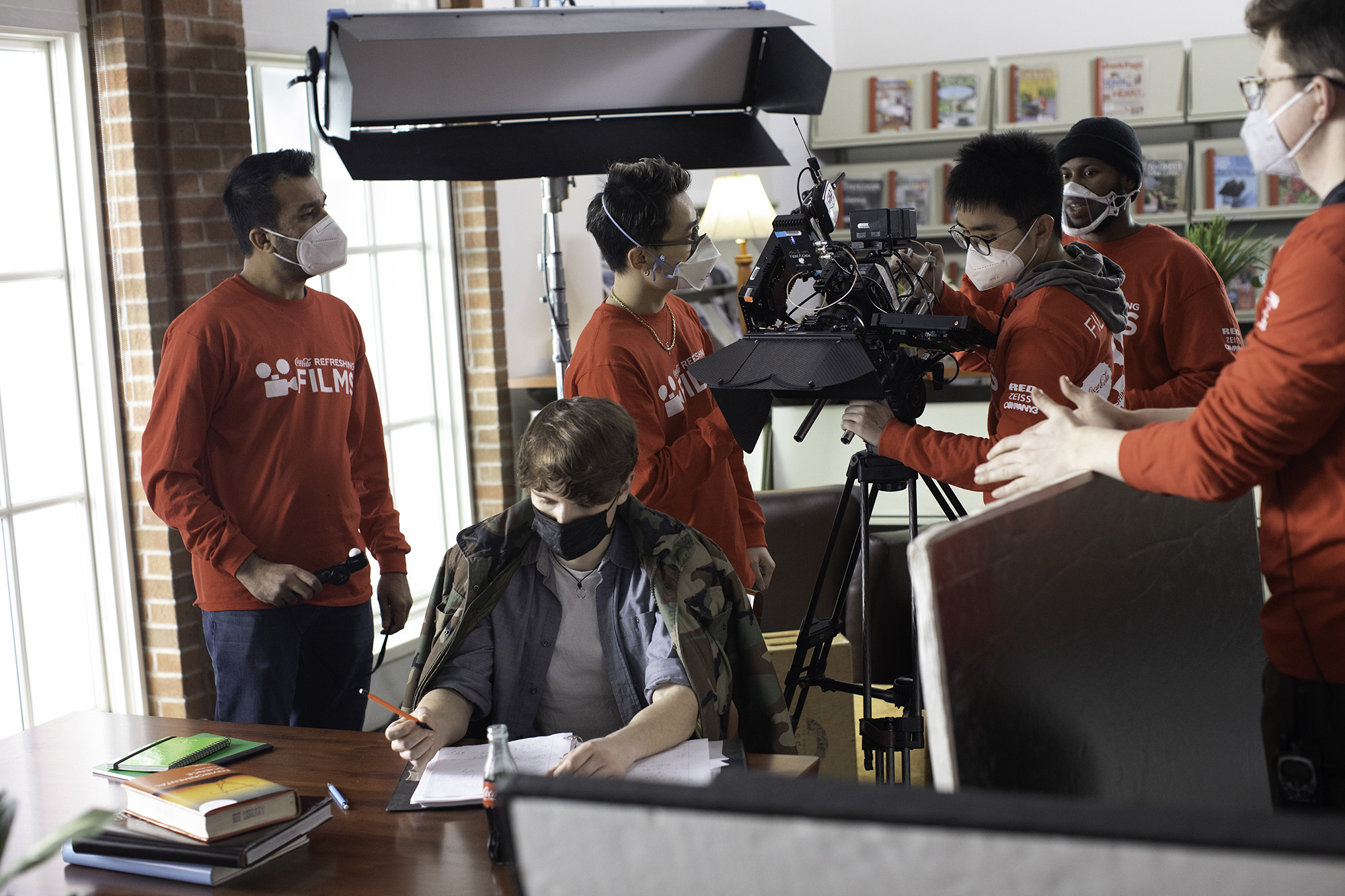 A production crew works on location at the Pittsford library.