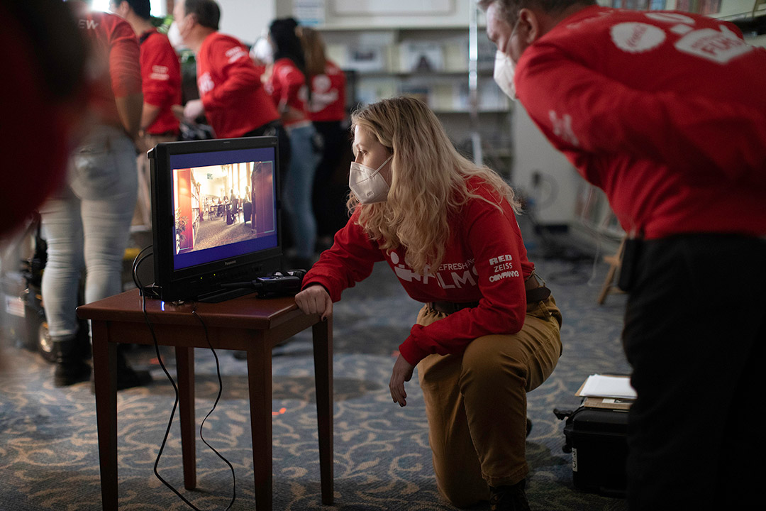 student reviewing a movie scene on a TV.