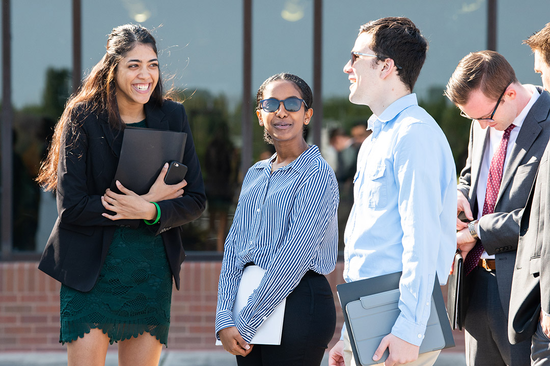 Students talk outside Gordon Field House.