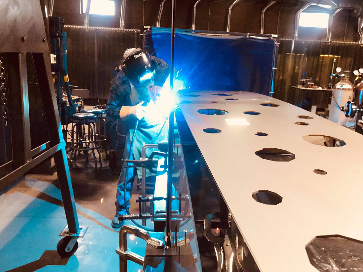 Carlos Caballero-Perez works on his new sculpture in the studio