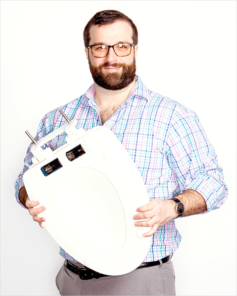 researcher holding toilet seat.