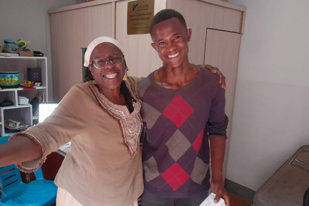 Black woman and man standing in an office.