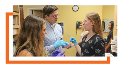 Chelsea Weidman Burke and her husband in a lab