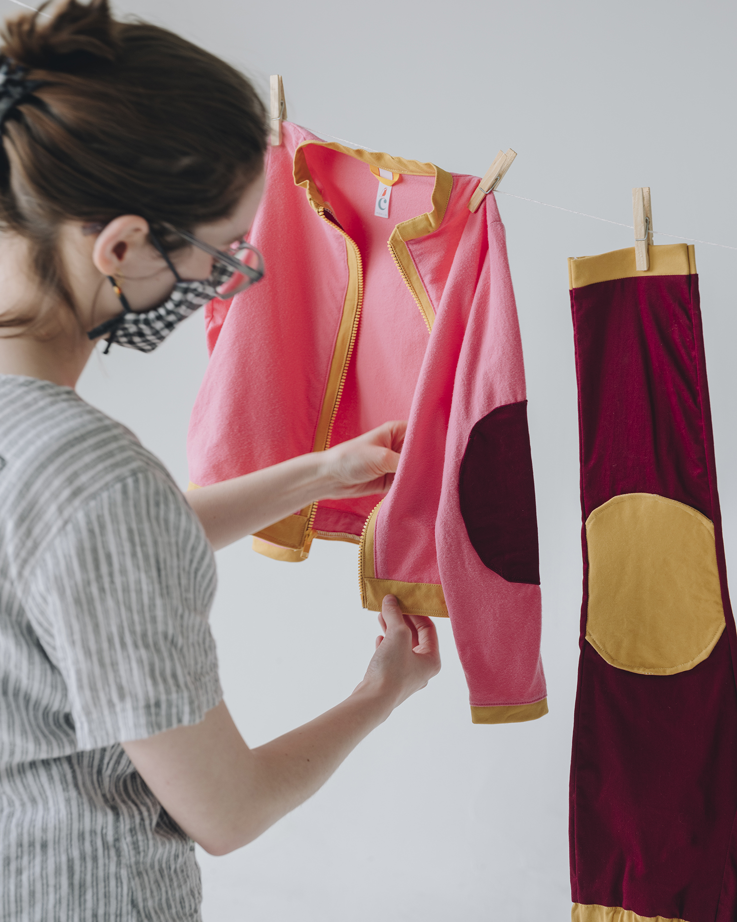 Daeya Shealy hangs clothes she designed from a clothesline.