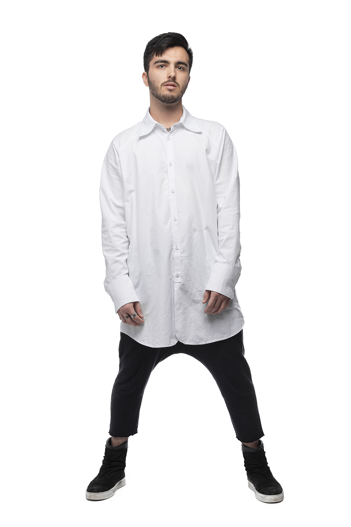 A functional clothing design of a white shirt and short black pants.