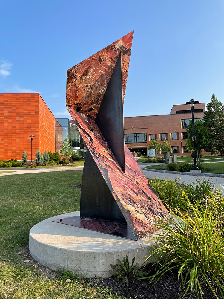 outdoor sculpture with an image of the surface of the moon.