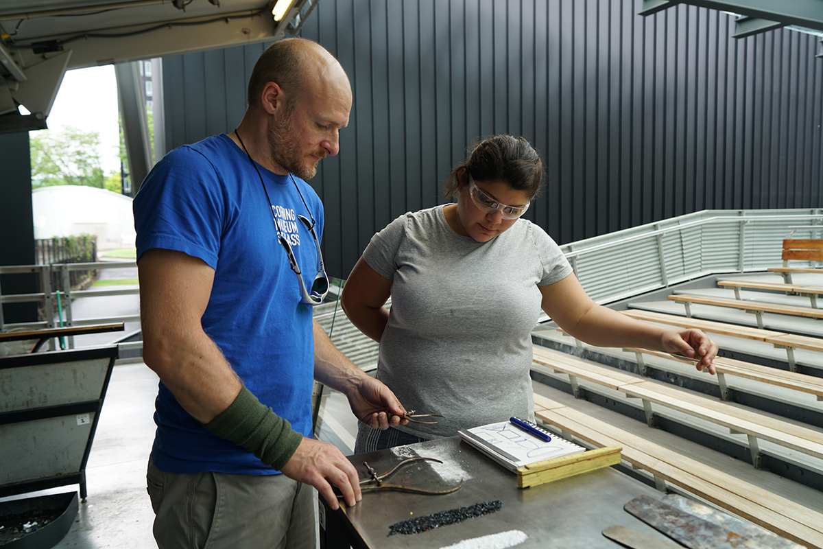 Andrea Gonzalez Esteche with a glassblower at CMoG