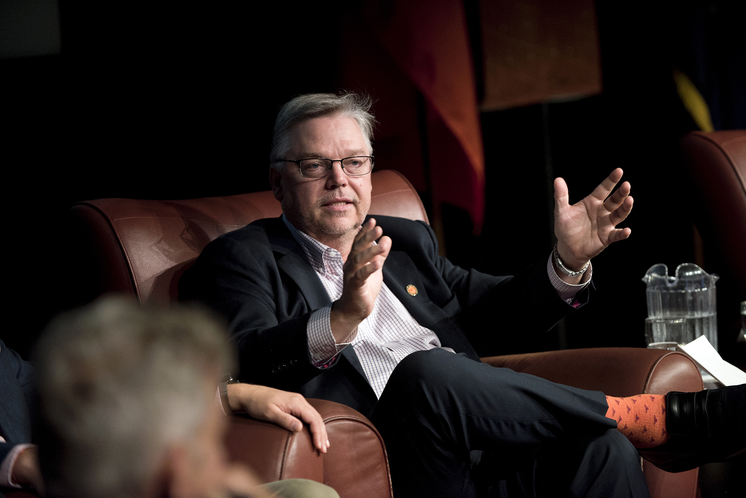 Man sits in chair talking