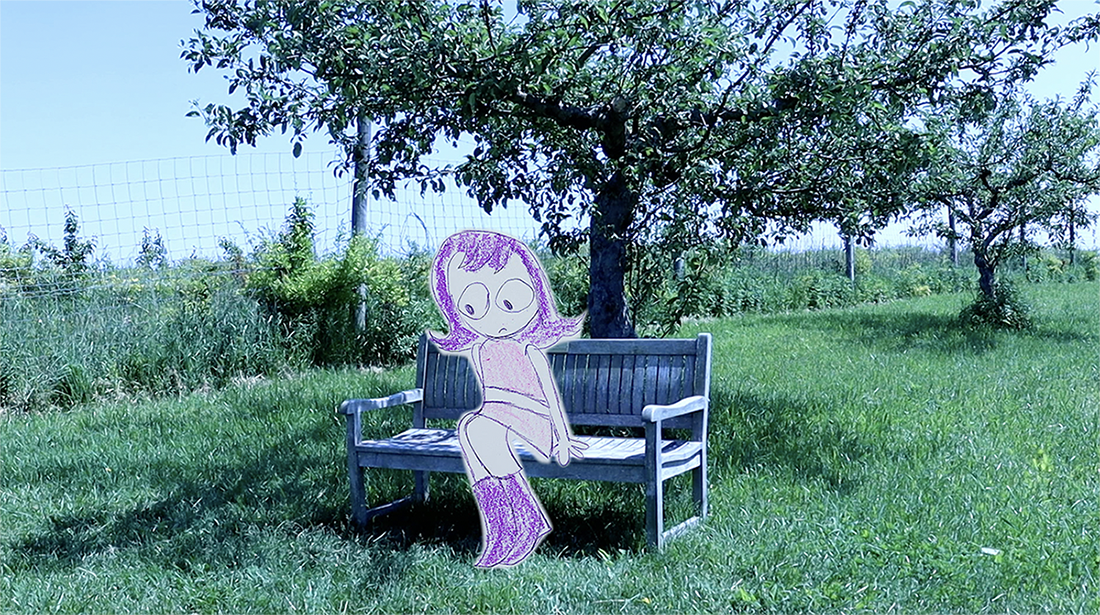 A stop motion character sits on a park bench.