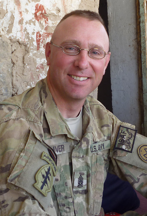portrait of David Oliver in Army fatigues.