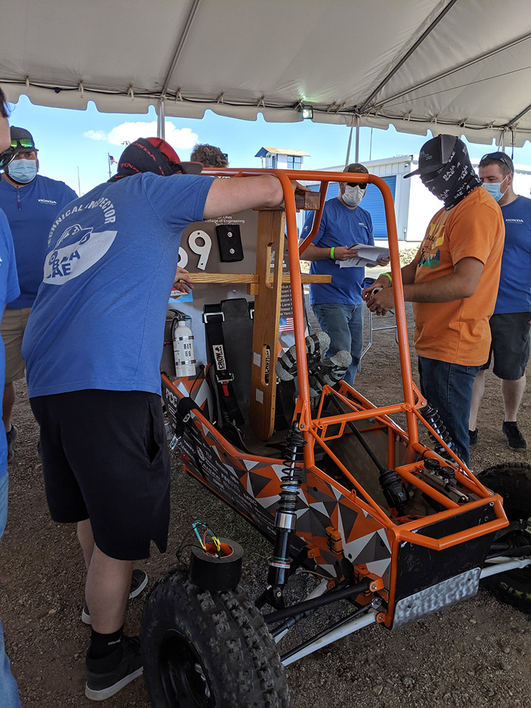 students examine baja car.