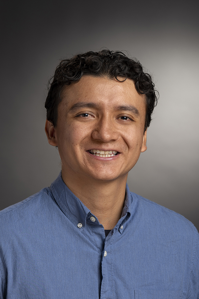 A headshot of RIT professor, Jairo Diaz wearing a blue collared shirt.