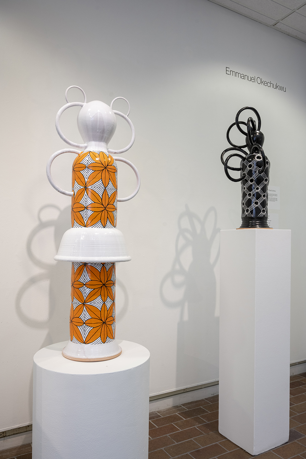 A colorful ceramic sculpture on a pedestal in Bevier Gallery.