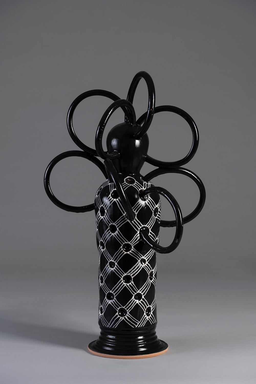 A ceramic sculpture with African-inspired motifs.