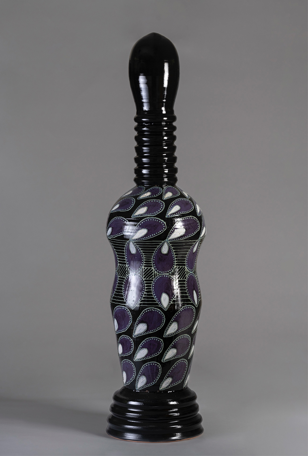 A ceramic sculpture with African-inspired motifs.