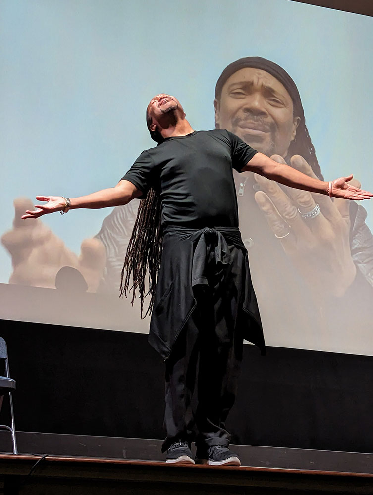 man standing on a stage about to take a bow.