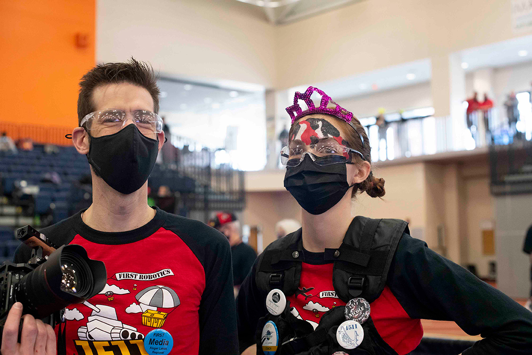 two people wearing masks.