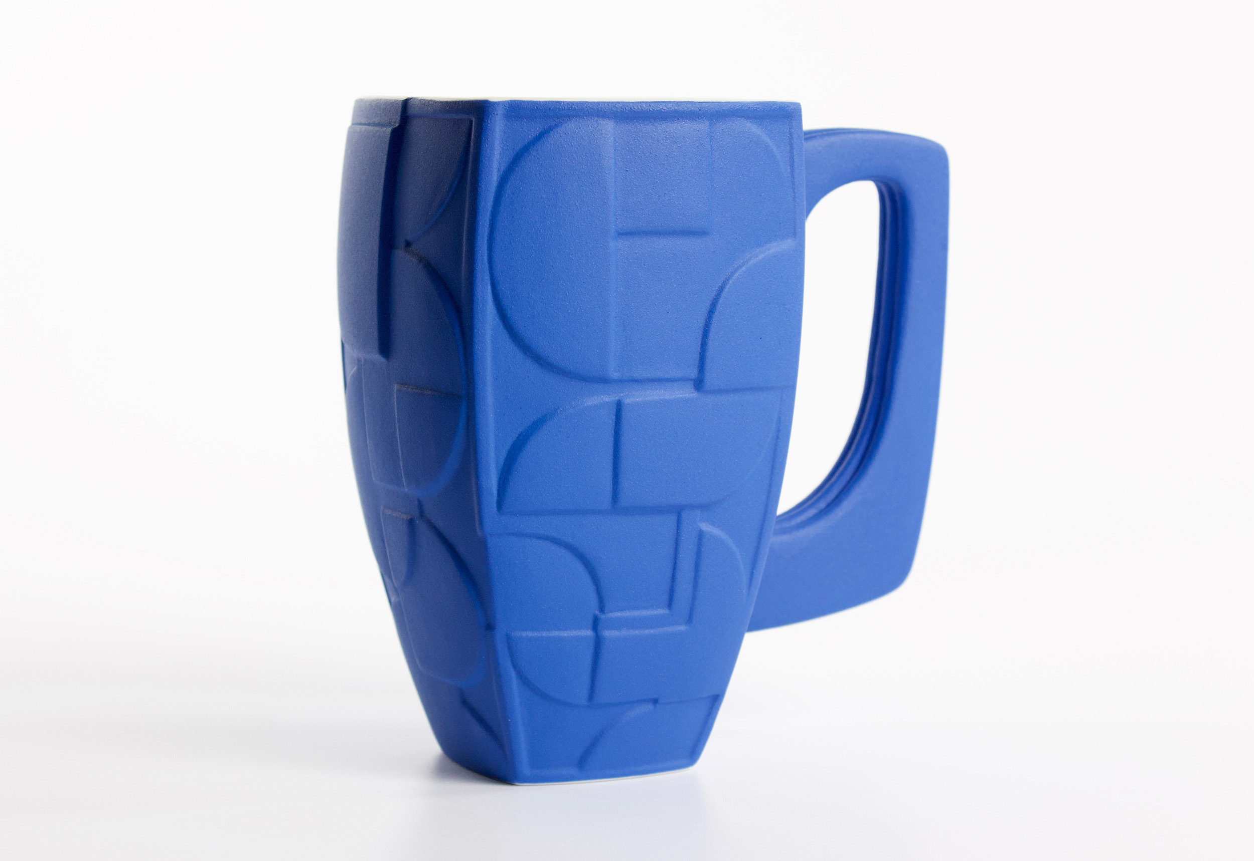 A blue, ceramic slip-cast cup.