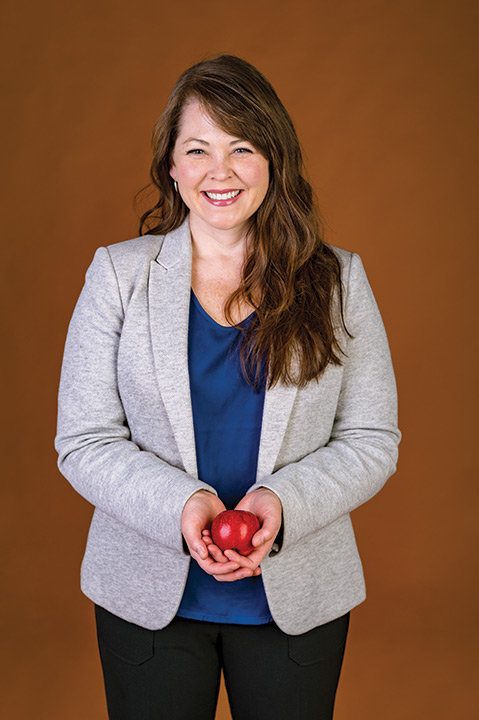 Woman holds apple.