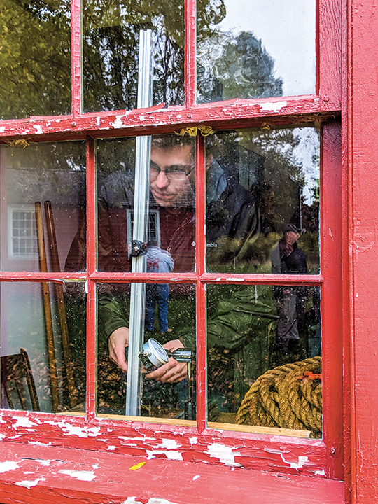 Student measures window panes.