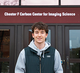 Gabriel Peters standing in front of the Carlson building at RIT