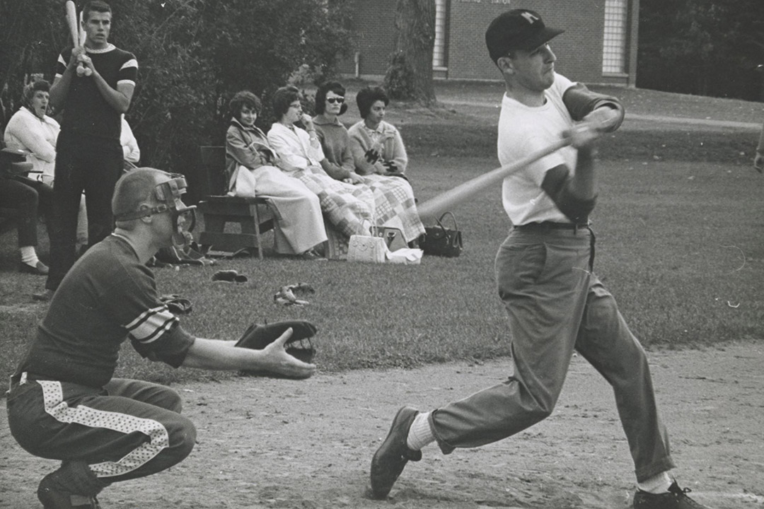black and white photo of people playing baseball.