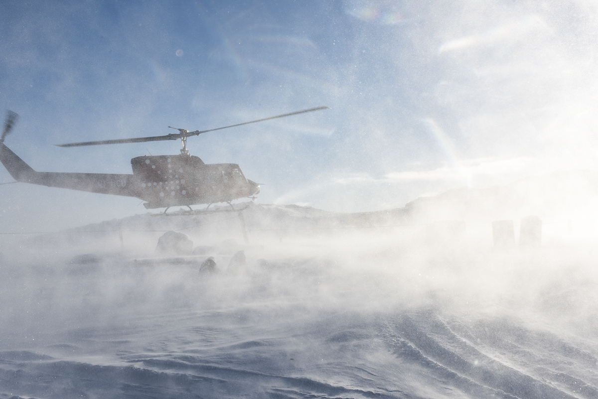 A Greenland helicopter lands on a helipad. The photo was taken as part of Denis Defibaugh's NSF grant.