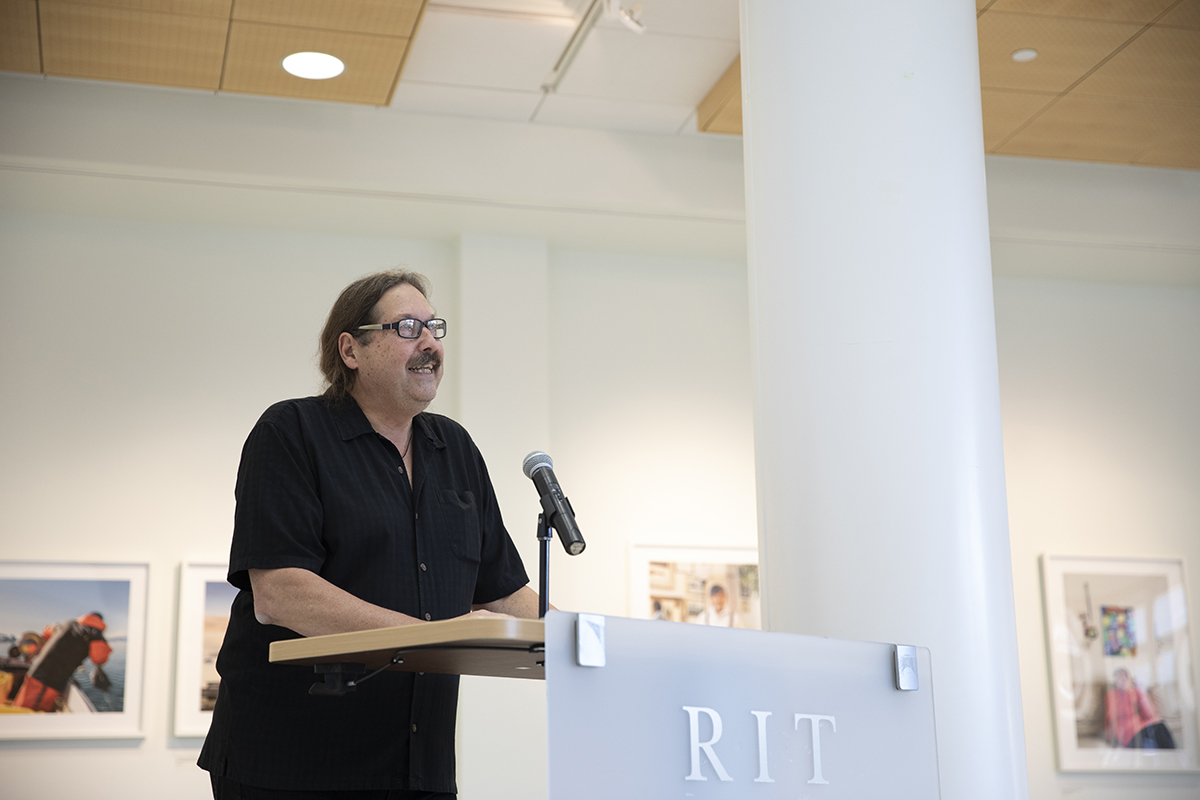 Denis Defibaugh gives remarks at the opening reception of his exhibit. The photo was taken as part of Denis Defibaugh's NSF grant.