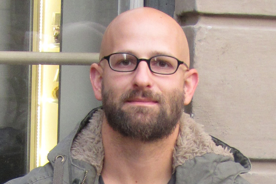 Head and shoulders view of man with glasses and beard.