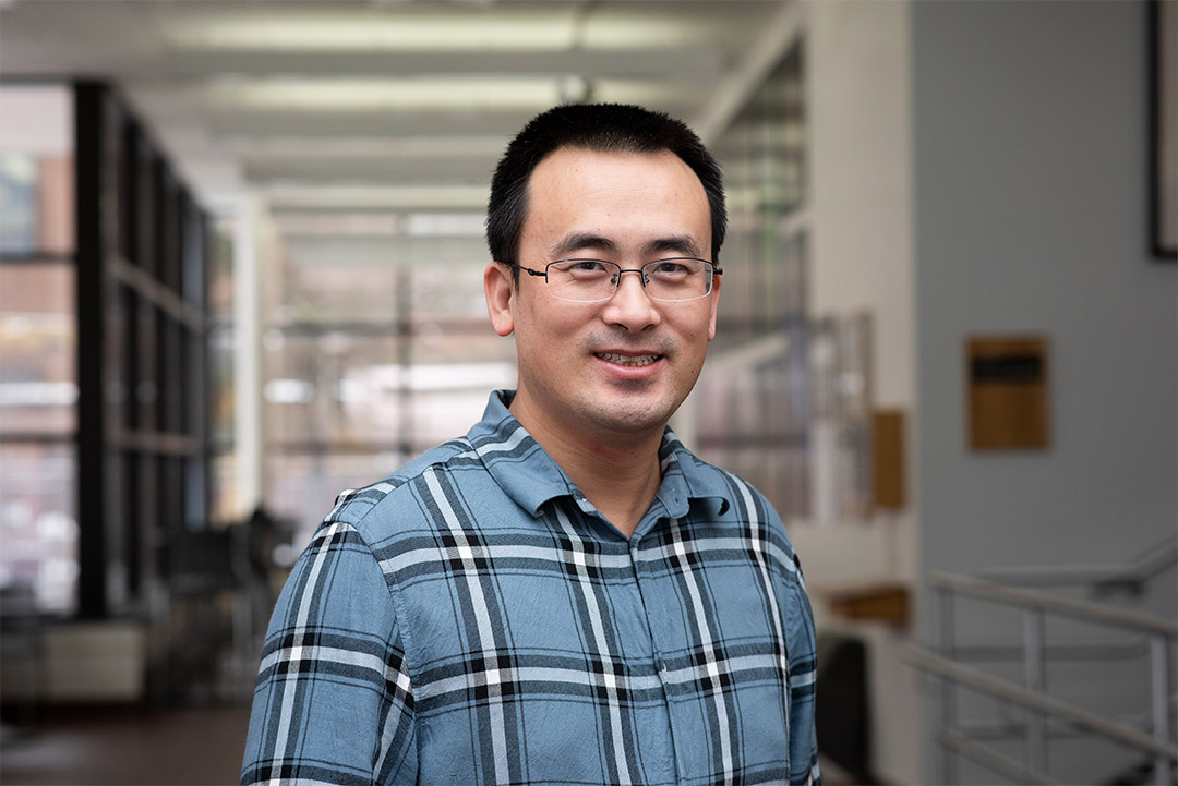 environmental portrait of Assistant Professor Guoyu Lu.