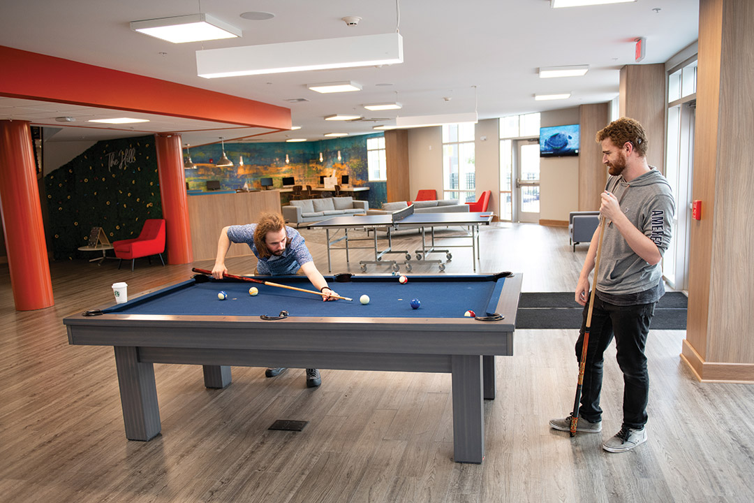 two people playing billiards.