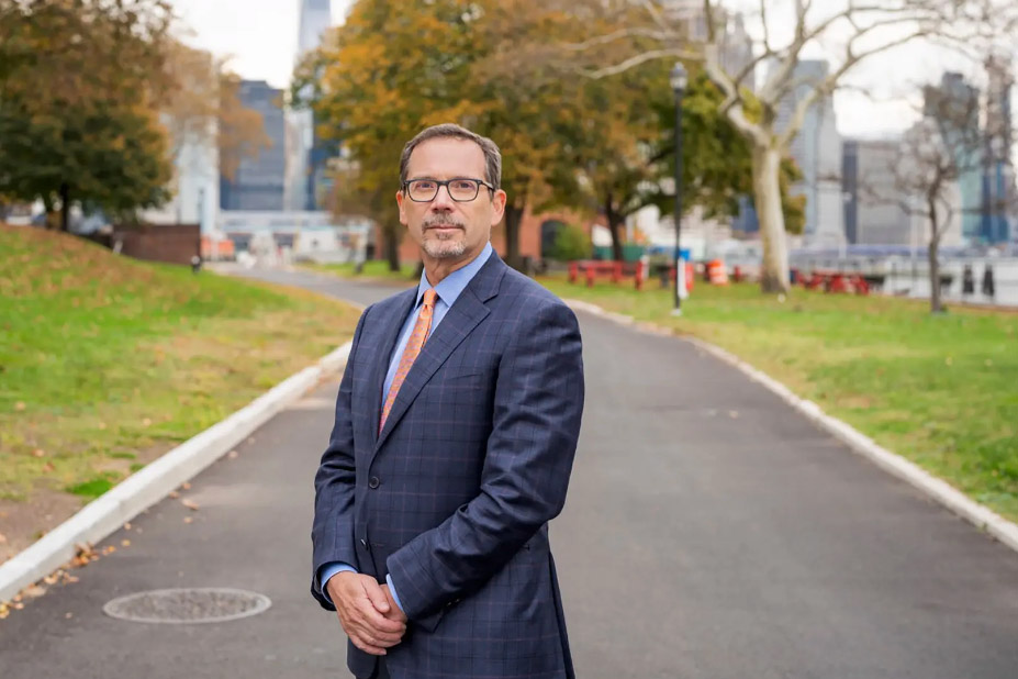 man posing for a portrait in a New York City park.