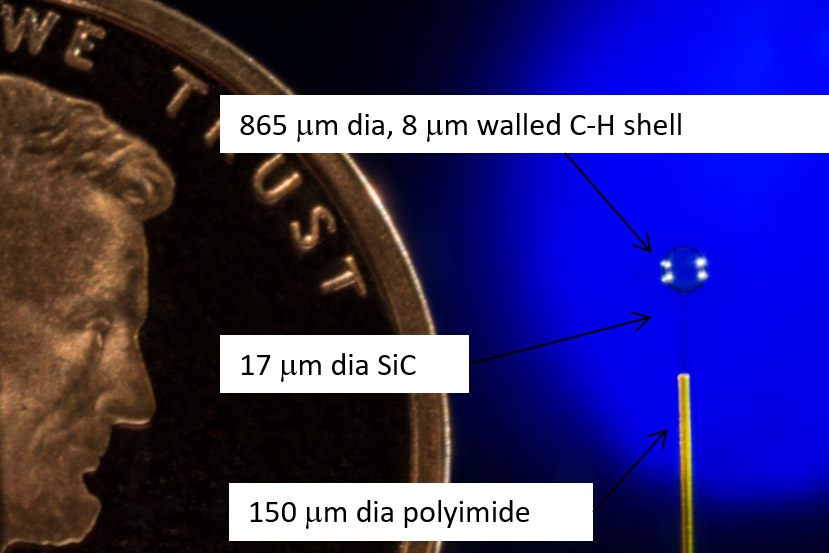 860 micro-meter diameter plastic shell supported by a 17-micro meter silicon carbide fiber.